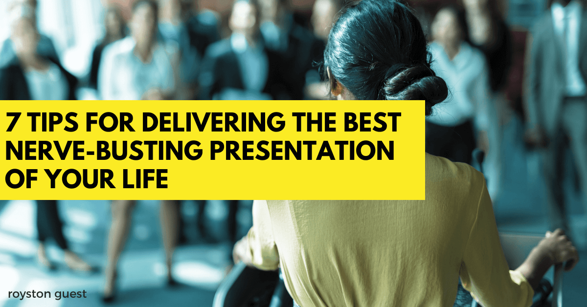 woman standing at lecturn giving a presentation